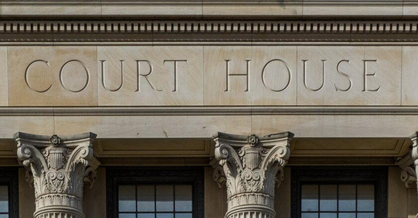 Close-up of the words "court house" on a building.