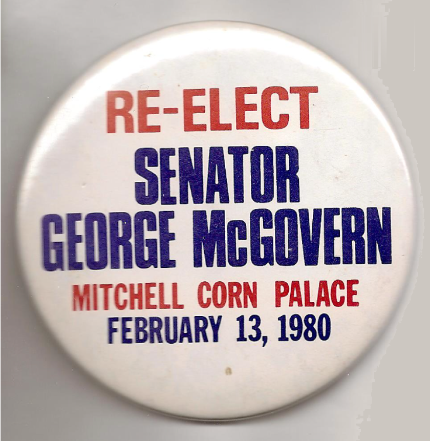 A McGovern campaign button from 1980 that reads “Re-elect Senator George McGovern / Mitchell Corn Palace / February 13, 1980.”