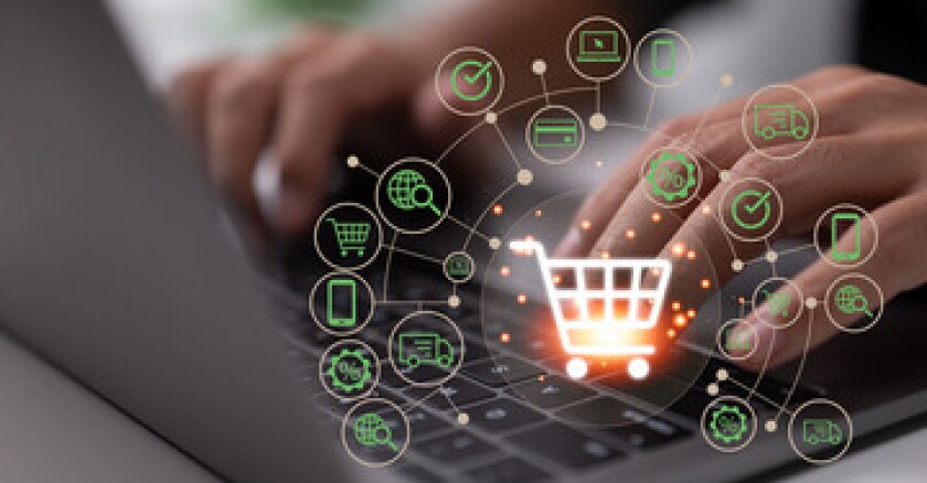 Closeup of someone typing on a laptop with a virtual shopping cart symbol over the image.