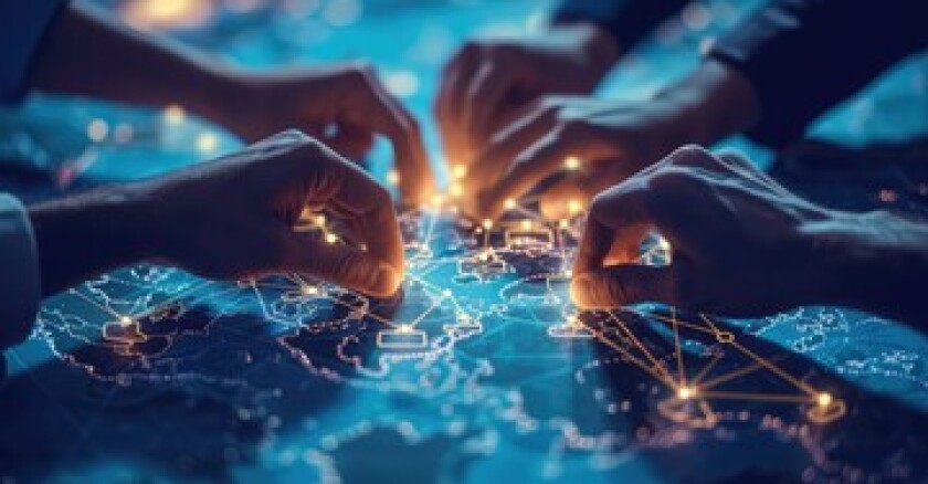 A group of people putting their hands on an illuminated map.