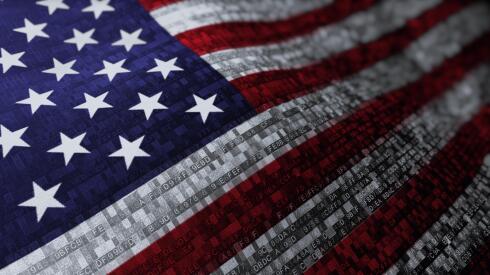 Closeup of the American flag formed by colorful lines of code.