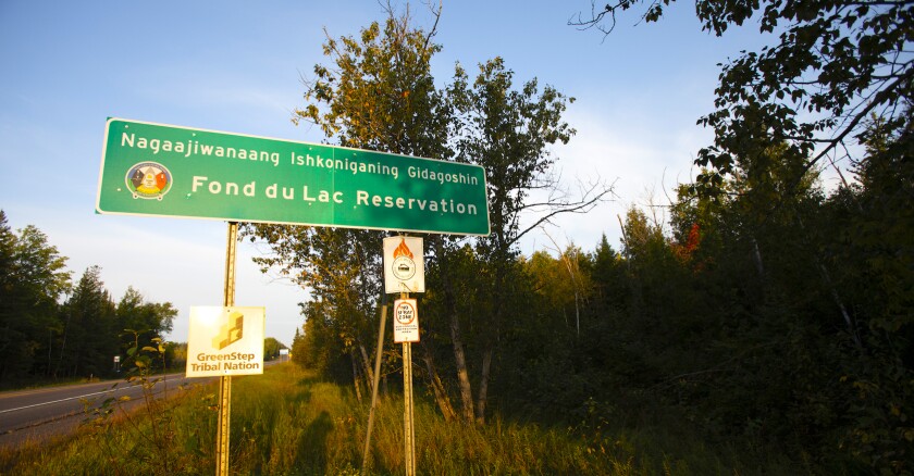 Road sign in Ojibwemowin designating the Fond du Lac Reservation.
