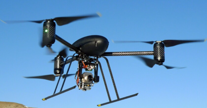 A drone flying against a blue sky.