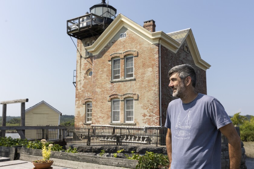 Patrick Landewe standing in front of the Saugerties Lighthouse.