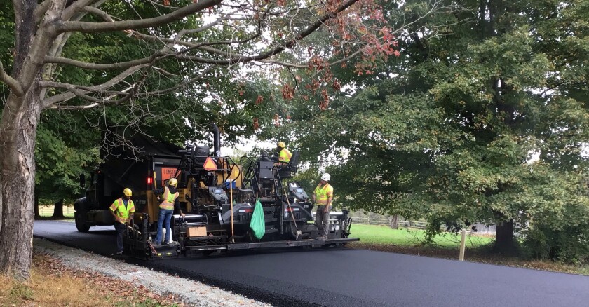 workers laying new road pavement