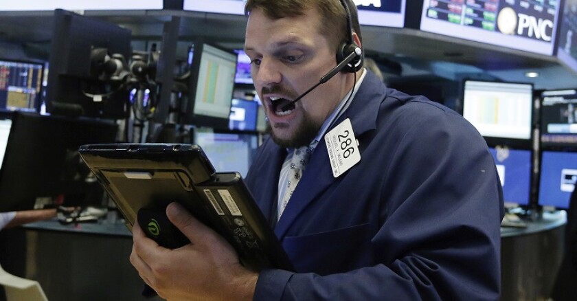 A trader works on the floor of the New York Stock Exchange.
