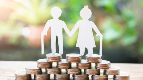 Couple,Older,Model,Standing,On,Money,Coins,Saving,For,Concept