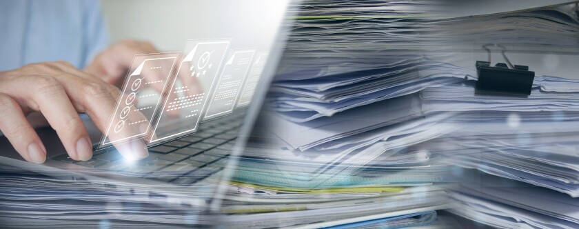 A stack of papers on the right and a laptop on the left with hands typing on the keyboard and digital illustrations of documents hovering above the keyboard.