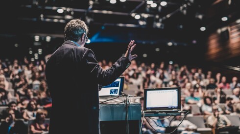 public speaker presenting a talk at an event