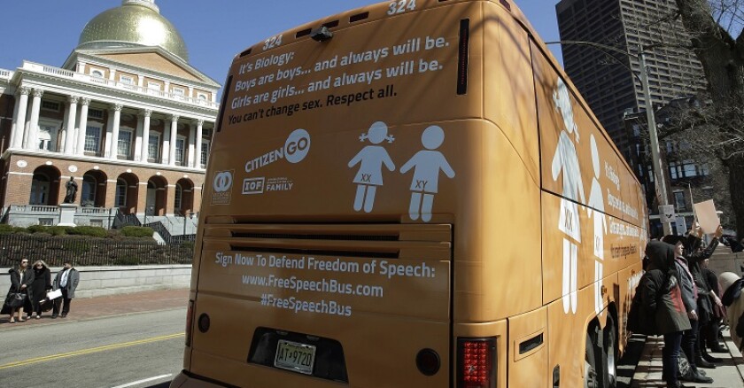 People protest transgender protections outside the Massachusetts Statehouse.