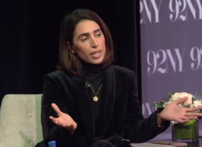 Yasmin Green, seated, gestures with both hands