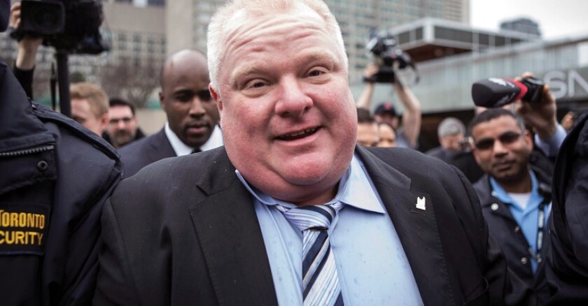 Rob Ford walks near reporters