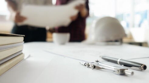 compass and papers on an architect's desk