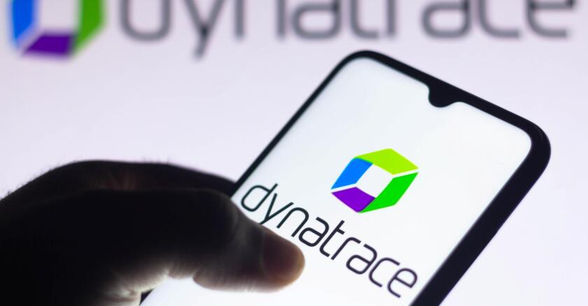 The Dynatrace logo on a smartphone's screen and in the blurred background.