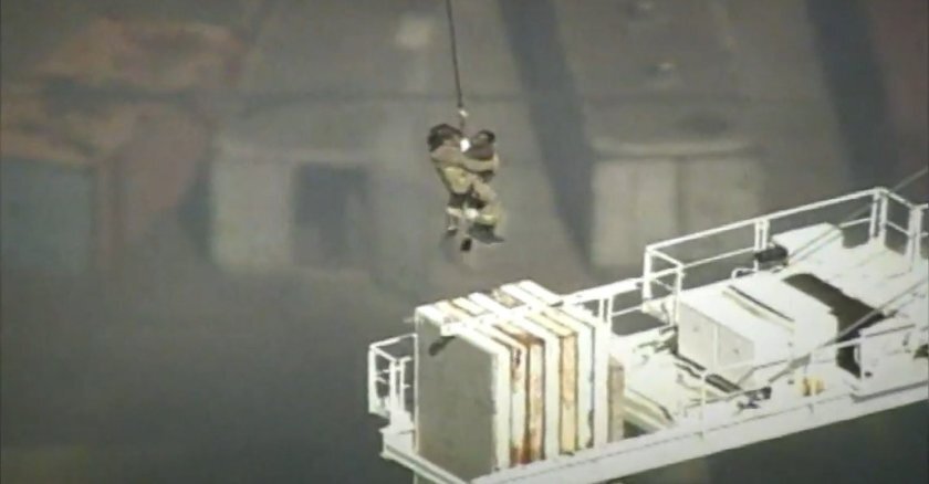 Atlanta firefighter Matt Moseley rescues Ivers Simms.