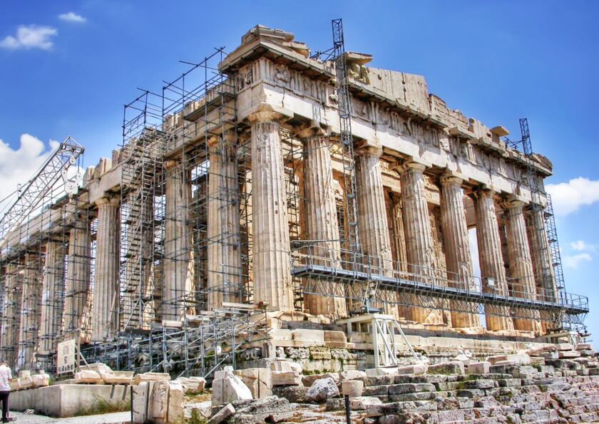The ruins of the Parthenon covered in scaffolding.