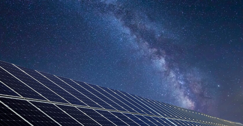 Solar panels under the night sky.