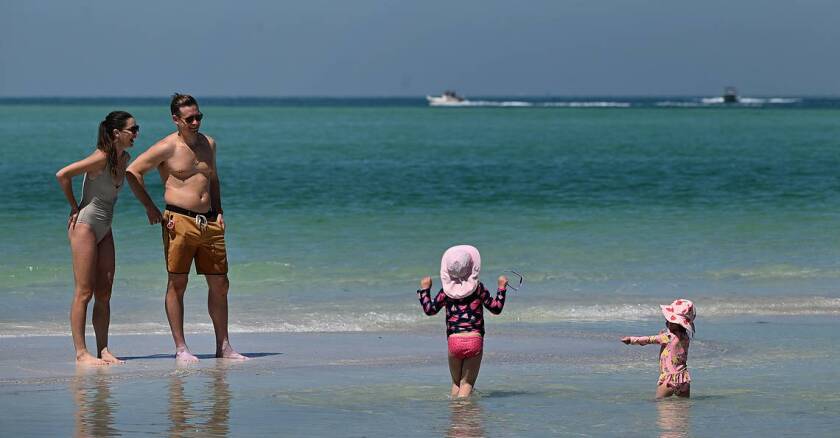 A family on the beach in Bean Point on the northern tip of Anna Maria Island in Florida.