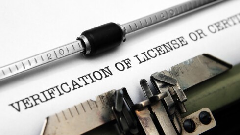 Closeup of text that was just typed on a typewriter that reads "Verification of License or Certificate."