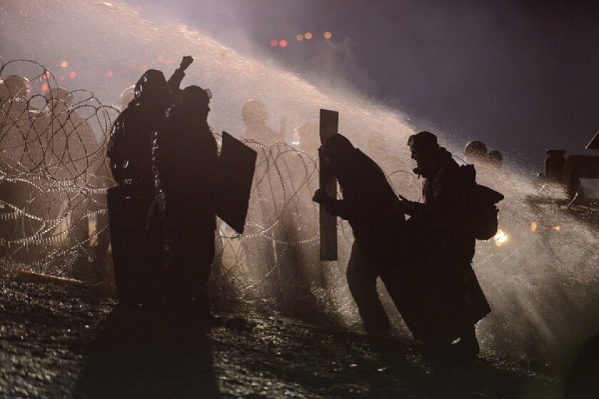 Police use a water cannon on protesters during a protest against plans to pass the Dakota Access pipeline near the Standing Rock Indian Reservation, near Cannon Ball, North Dakota, U.S.