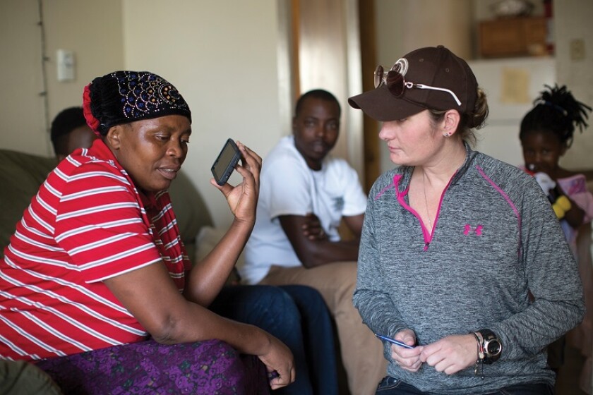 Congolese woman speaks to a refugee center caseworker