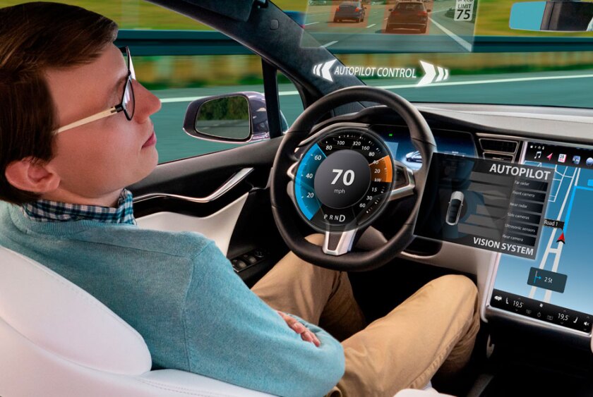 person+in+the+drivers+seat+of+an+autonomous+vehicle