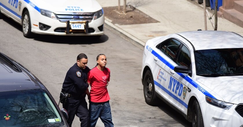 NYPD cop arresting a young black man.