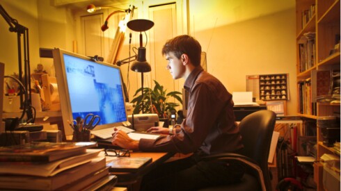 A person working on a computer in their home.
