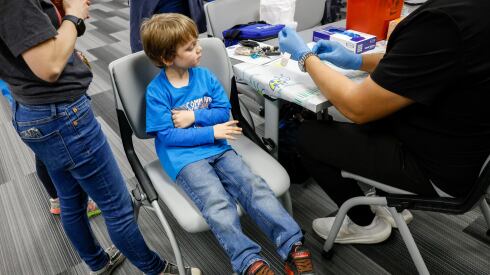 Mickie Palmer, 6, of Carrollton, watches as a nurse prepares a dose of the measles, mumps and rubella virus vaccine at a pop-up clinic at the Carrollton-Farmers Branch ISD Administration Building in Carrollton, Texas, on Friday, March 7, 2025.