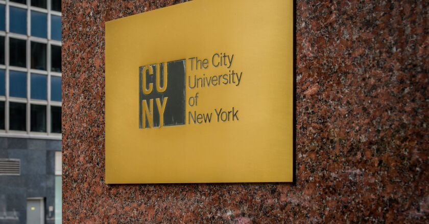 A sign on the side of a building that says "The City University of New York" next to the CUNY logo.