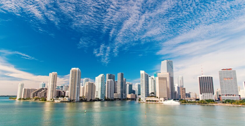 The Miami skyline on a sunny day as seen from the water.