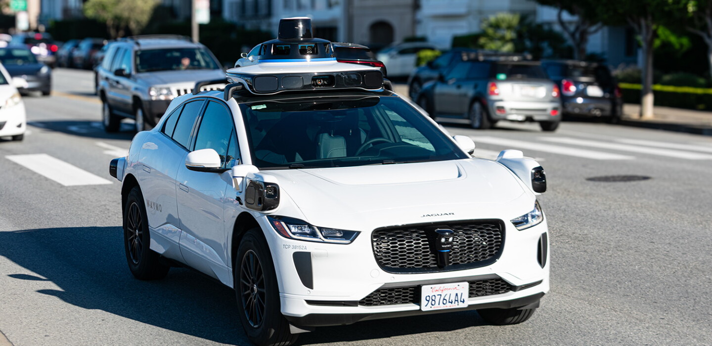 Photo: governing.com Waymo One Jaguar driverless autonomous car equipped with lidar sensors and cameras drives on a multi-lane city road. Front