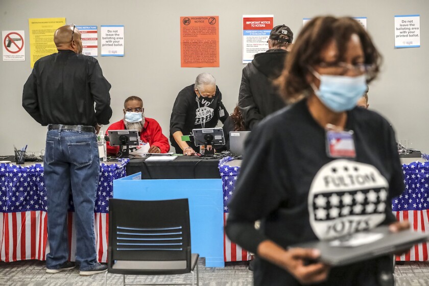 People checking in at a table for early voting.