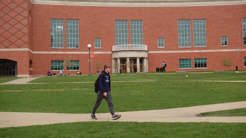 Student walking in front of the engineering library at the University of Illinois