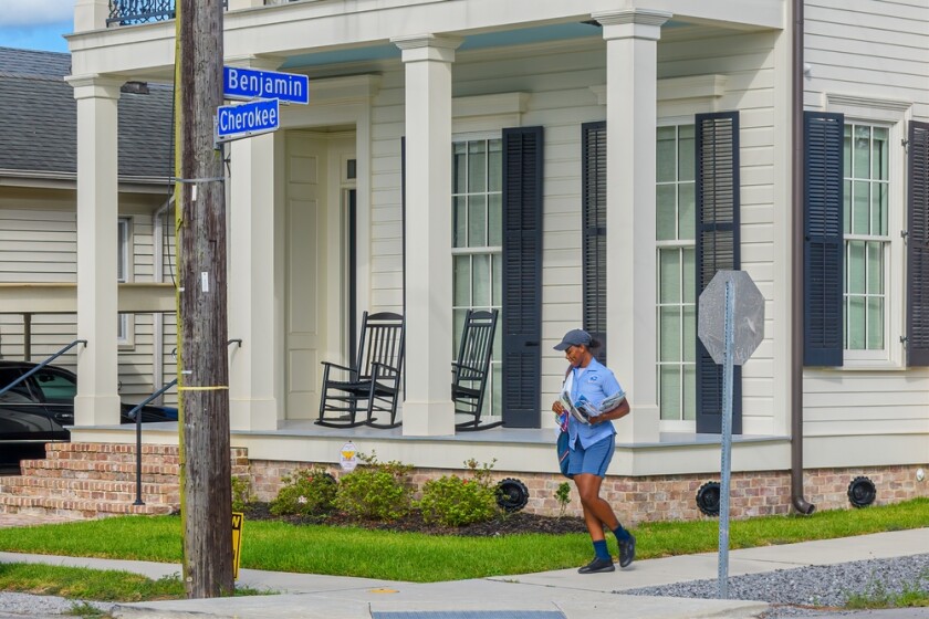 A postal worker delivers mail in New Orleans, Louisiana
