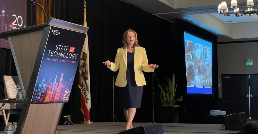 California CIO Liana Bailey-Crimmins standing on a stage speaking to an audience at a conference.