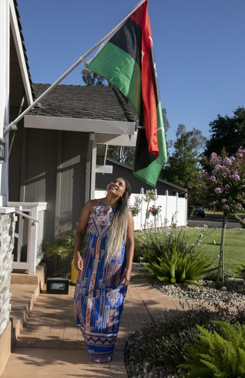 Sheri Wilson outside her Elk Grove, Calif., home with the Pan African flag.