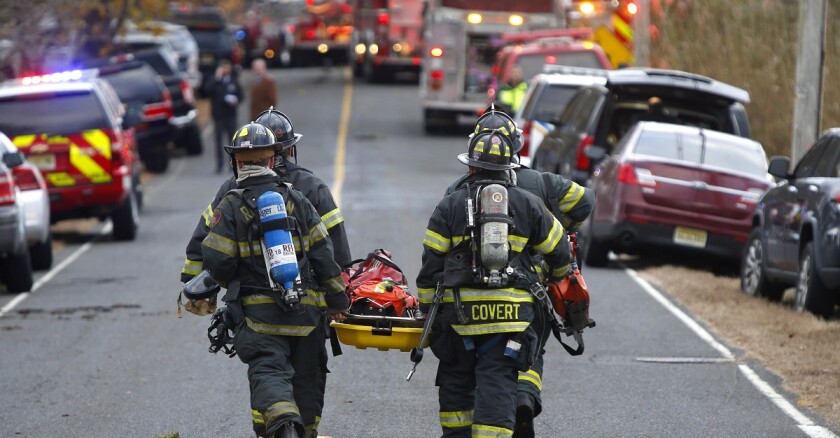 Firefighters carry a stretcher.