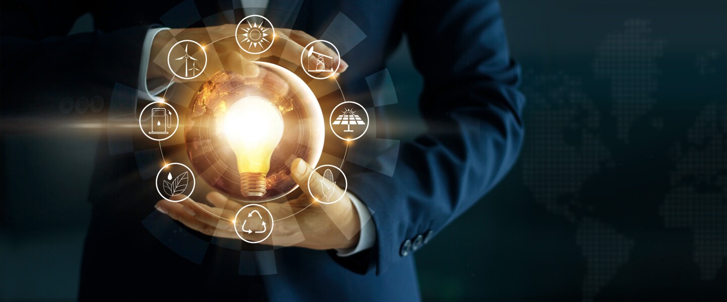 Businessman,Holding,Light,Bulb,With,Energy,Sources,Icon.,Campaigning,For