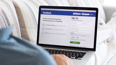 Person on Facebook on their couch.