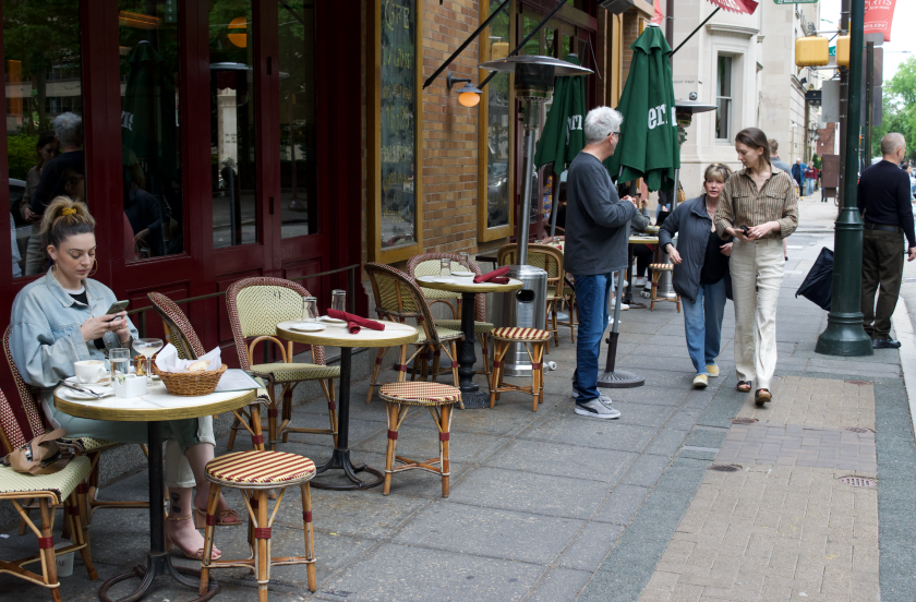 Outdoor restaurant seating on a sidewalk.