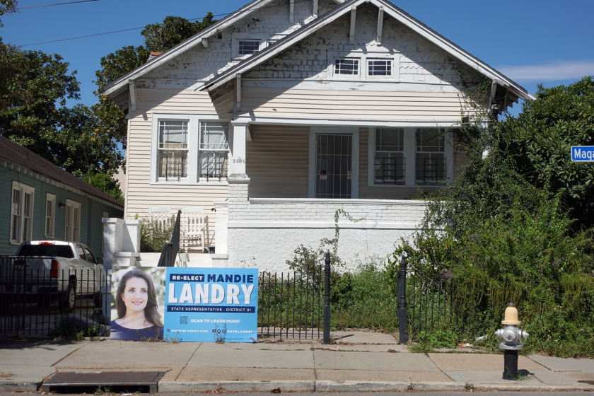 a yard sign that says "re-elect Mandie Landry"