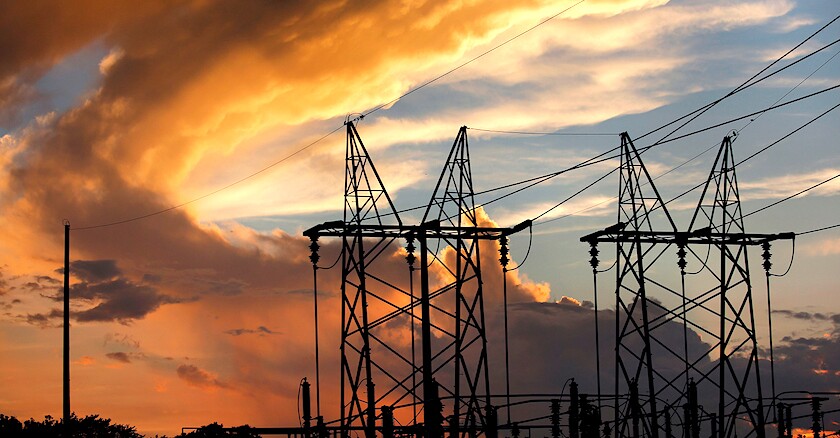 Power lines against a sunset.