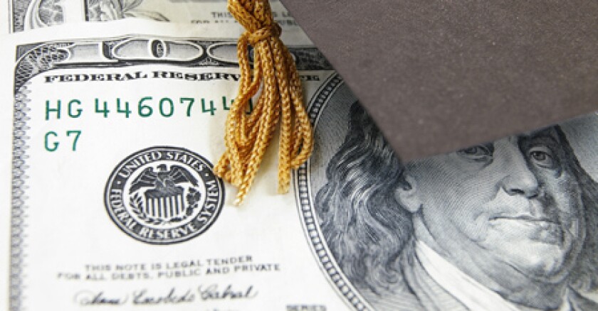 A small graduation cap on top of a $100 bill.