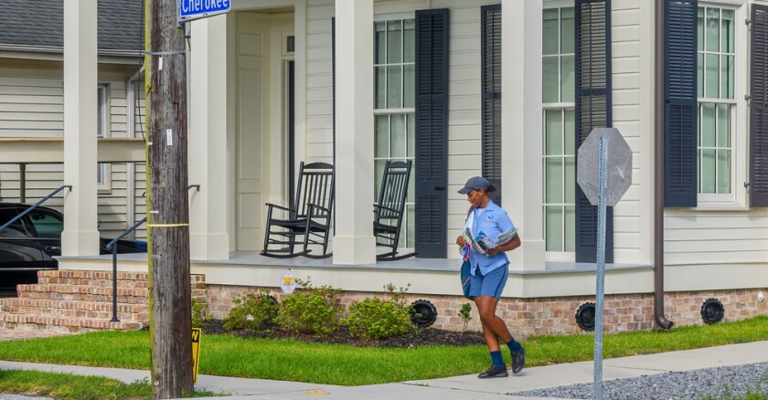 A postal worker delivers mail in New Orleans, Louisiana