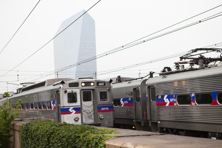 Two SEPTA trains stopped at an open-air station.