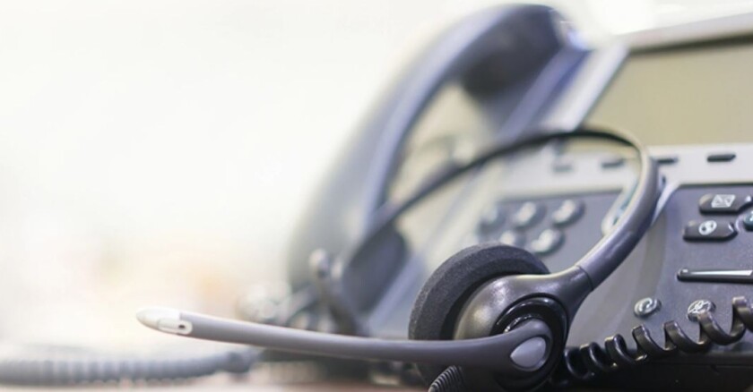 A desk phone and attached headset.