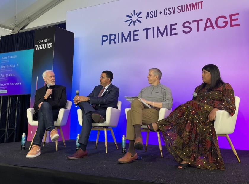 Paul LeBlanc, John King Jr., Arne Duncan and Anurima Bhagarva seated on a stage participating in a panel discussion.