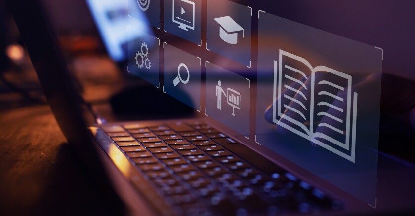Digital icons over a keyboard that indicate e-learning.