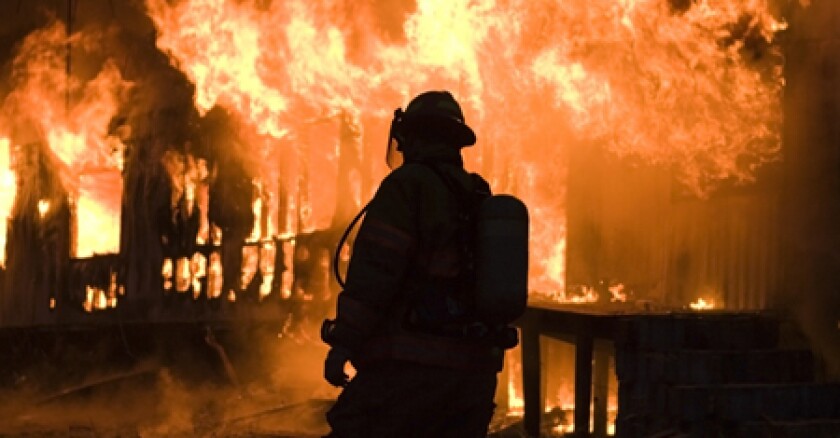 Firefighter's silhouette in front of flames